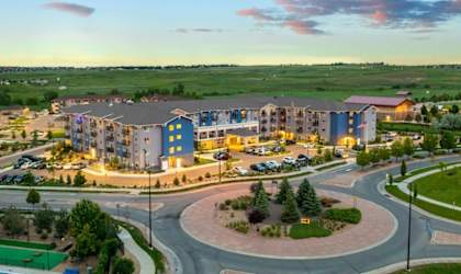 A large building complex with a roundabout in front of it.