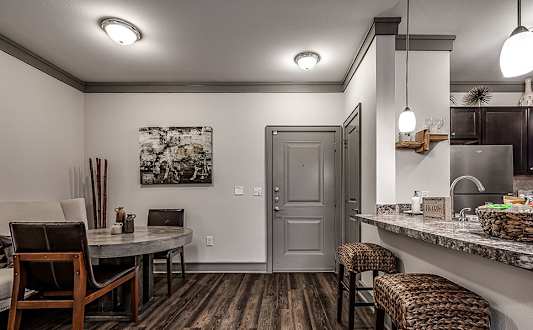 A kitchen with a bar area and a dining table.
