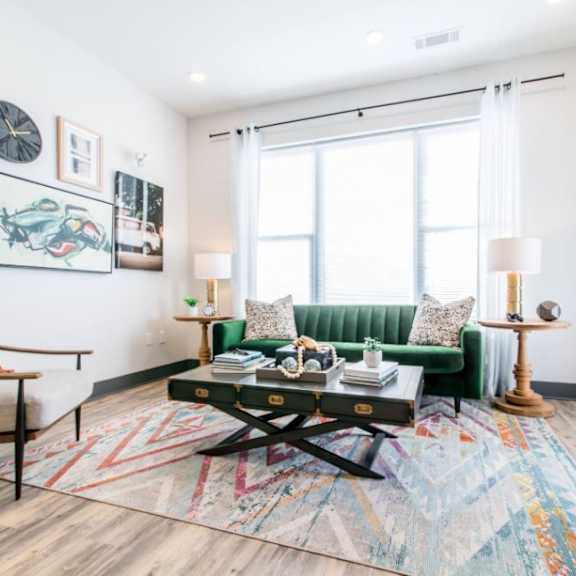 A living room with a green sofa and a wooden coffee table.