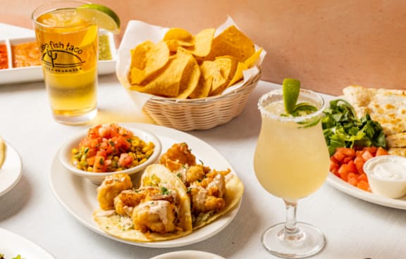 A variety of Mexican food is displayed on a table.