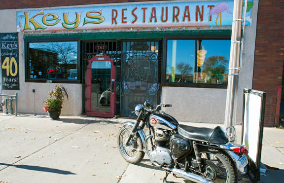 a motorcycle parked in front of a restaurant