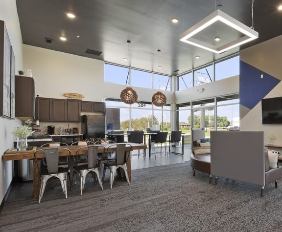 an open concept living room and kitchen with a large wall of windows and a vaulted ceiling
