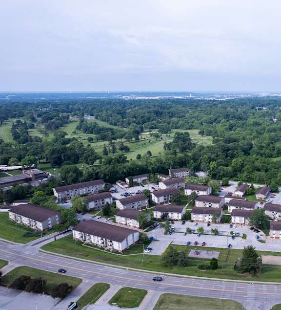 A bird's eye view of a residential area with houses and roads. at Kimberly Club Apartments, Iowa, 52807