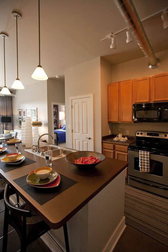 A kitchen with a table set for a meal at The Foundry Apartments , South Bend, IN, 46617