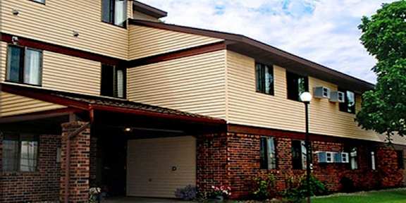 A two-story residential building with a garage.