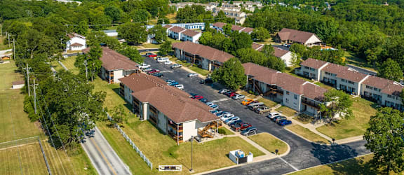 an aerial view of a building surrounded by trees