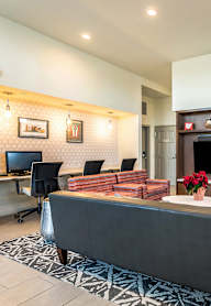 a living room with a couch and a fireplace and business center