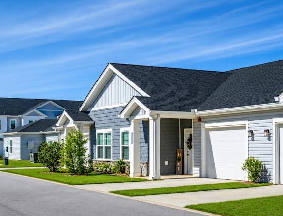 A row of houses with a clear blue sky above them.