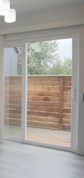 A room with a sliding door leading to a balcony at Tigardville Apartments, Tigard