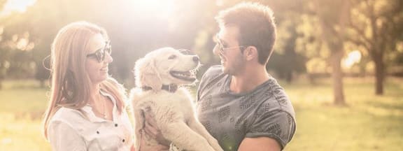 Woman and Man Holding Dog at The Pradera in Richardson, TX 75080