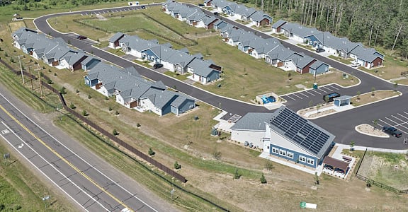 A bird's eye view of a residential area with houses and a roundabout.