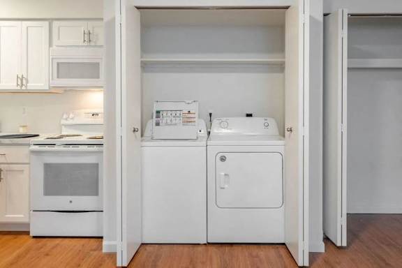 A white fridge and freezer are in a kitchen.
