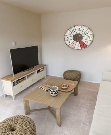 a living room with a large clock on the wall