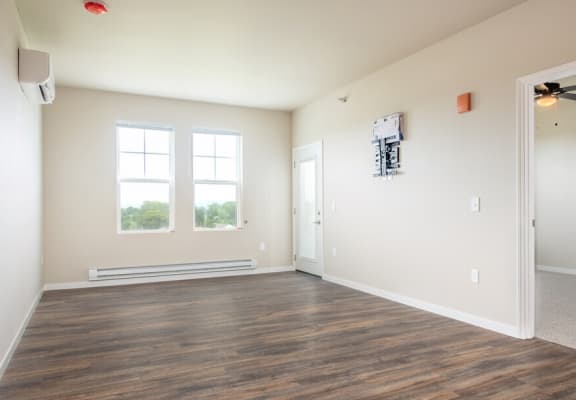 a living room with hardwood floors and beige walls