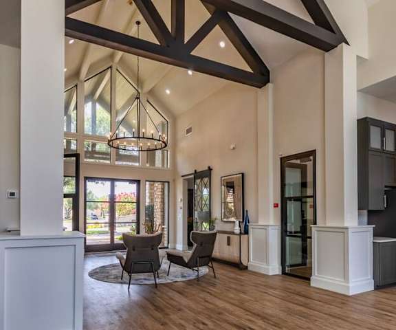 A modern living room with wooden floors and a large window.