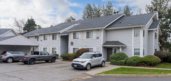 a white building with cars parked in front of it
