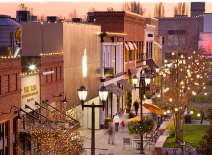 a city street at dusk with people walking down the street at Cuvee, Seattle, WA