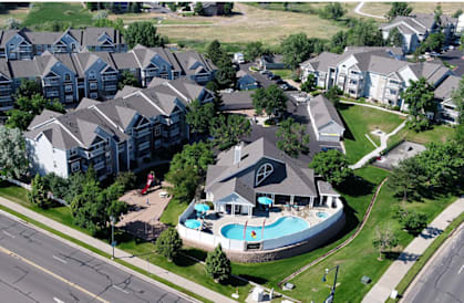 a large house with a swimming pool in front of it