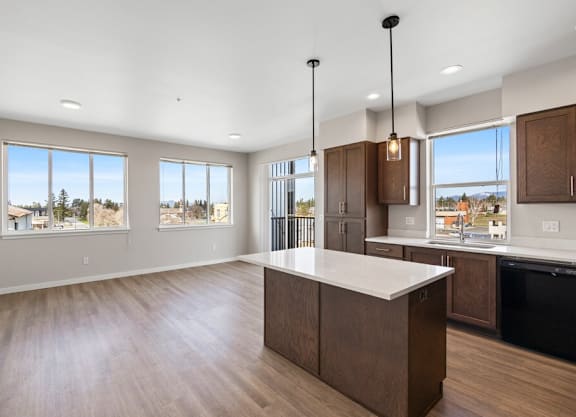 an open kitchen and living room with a large island