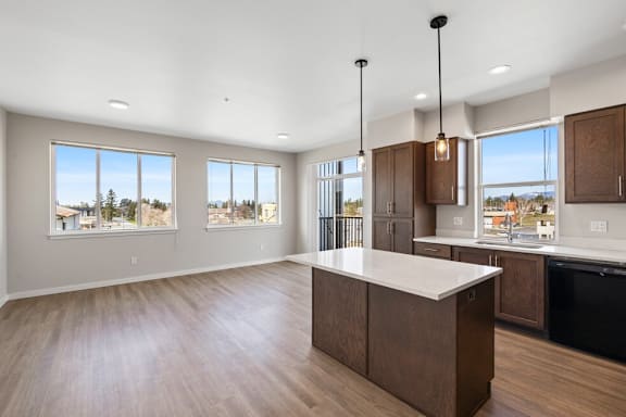 A kitchen with a large island and wooden cabinets.