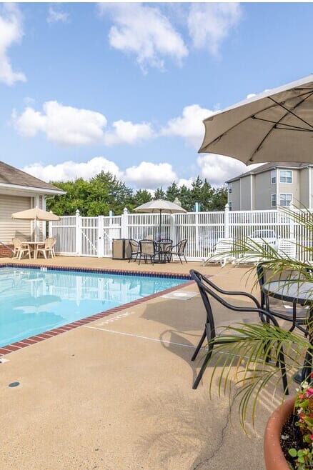 A patio with a chair and a small table.