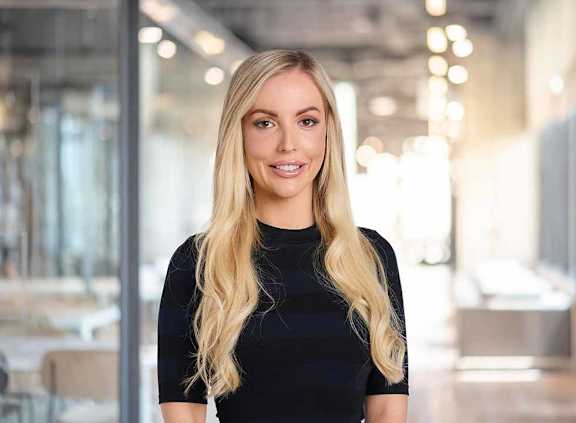 a woman with long blonde hair wearing a black dress