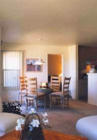 A living room with a couch, chairs, and a coffee table.