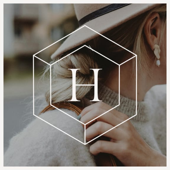 Woman Wearing Hat and Sweater Holding Purse