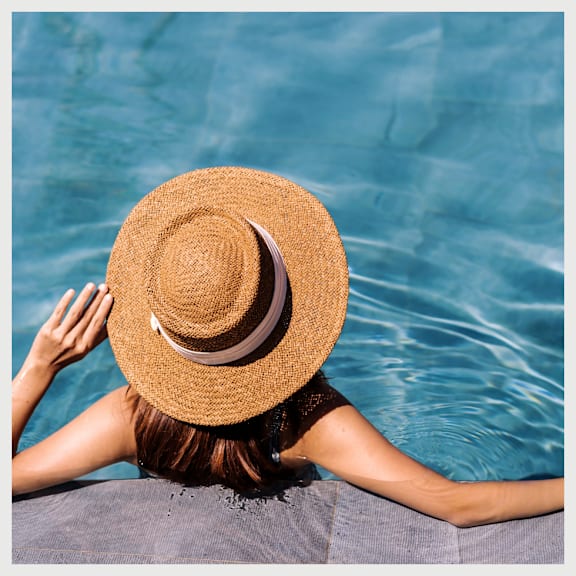 Woman Wearing Hat Relaxing in Pool