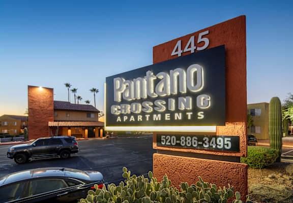 A sign for Pantano Crossing Apartments with a phone number on it.