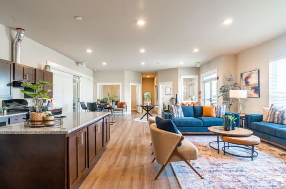 a living room with a kitchen and a blue couch