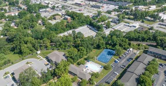 an aerial view of a city with a blue pool in the middle of a grassy area at Station JTown, Louisville, KY, 40299