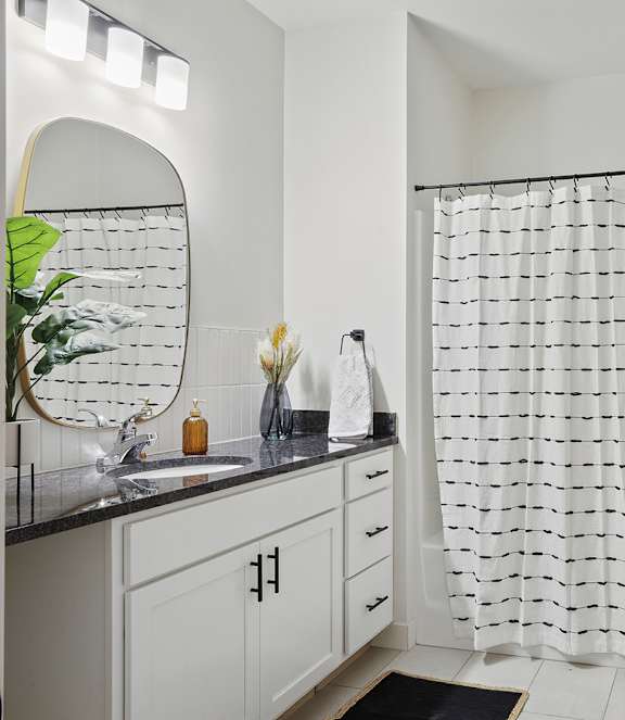A bathroom with a white toilet and a shower curtain.
