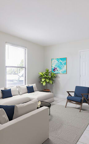 a living room with a white couch and a blue chair