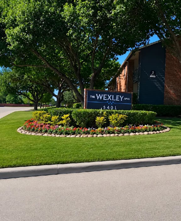 A sign for Wexley is in front of a building.