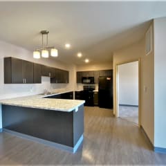 a kitchen with a large island with granite countertops