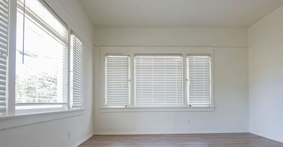 A room with wooden floors and white walls.