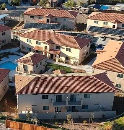 arial view of a neighborhood with houses and a pool