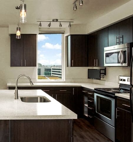 a kitchen with a large window and a sink