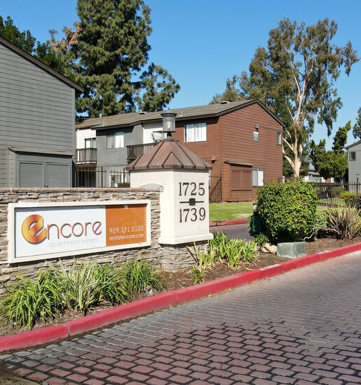Courtyard with Lush Landscaping and Walkways Surrounded by Tuscany Villas Apartment Buildings at Encore Apartments, 91764