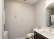 Thumbnail 37 of 48 - a bathroom with a mirror and a sink and a toilet