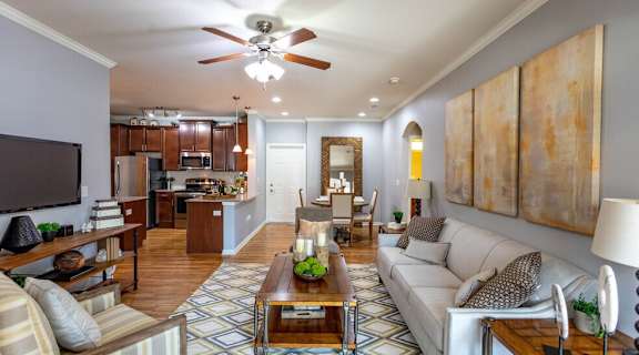 a living room with a couch and a ceiling fan