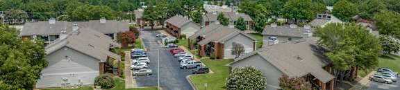 an aerial view of a neighborhood of houses with cars parked