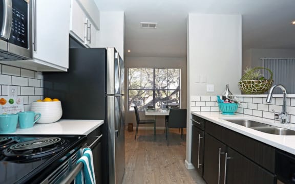 a kitchen with a sink and a refrigerator
