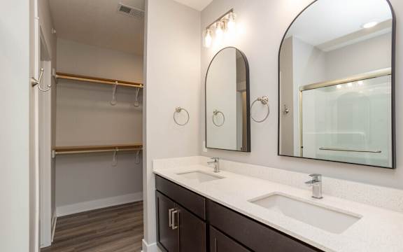 a bathroom with two sinks and a large mirror