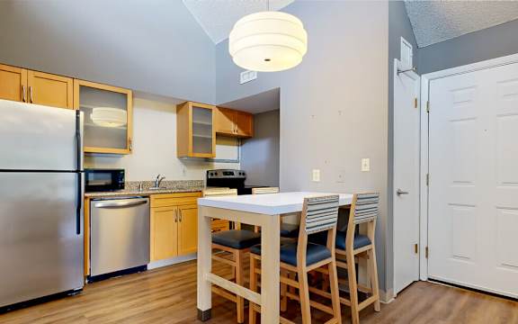 a kitchen with a dining table and a refrigerator