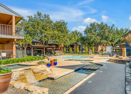 A residential area with a pool and a small waterfall.