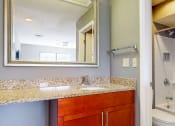 Thumbnail 15 of 16 - a bathroom with a sink and a toilet and a mirror