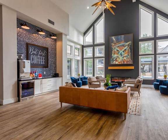 a living room with large windows and a couch