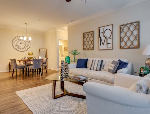 a living room with two couches and a coffee table at Magnolia Village Apartments, Jacksonville, FL, 32207